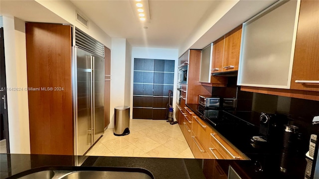 kitchen featuring light tile patterned flooring and appliances with stainless steel finishes