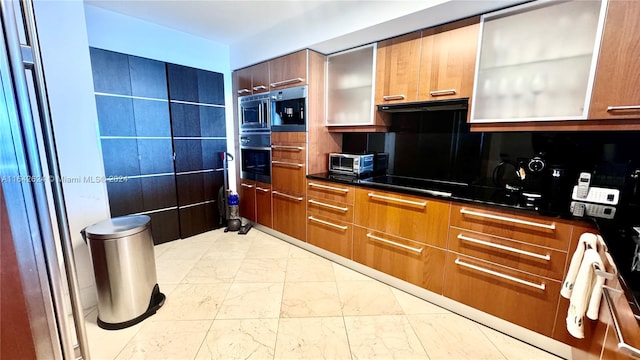 kitchen with wall oven, stainless steel microwave, black electric cooktop, and light tile patterned floors