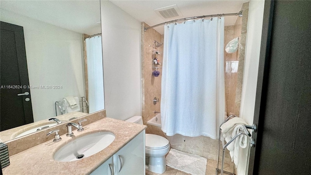 full bathroom featuring tile patterned floors, vanity, shower / bath combo, and toilet