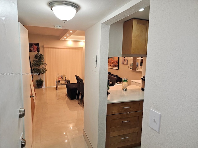 corridor with light tile patterned floors