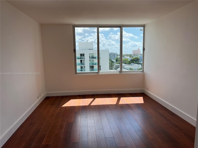 empty room featuring dark wood-type flooring