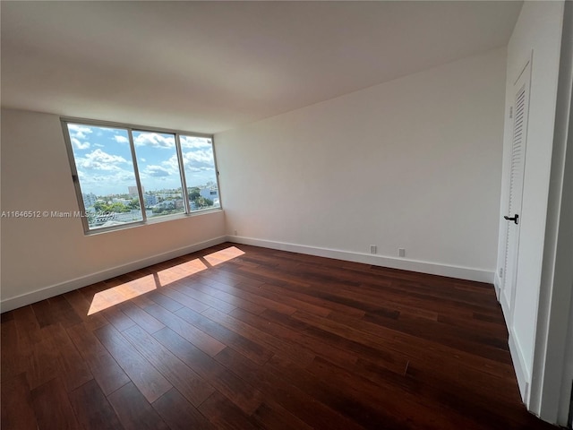 empty room featuring dark hardwood / wood-style flooring