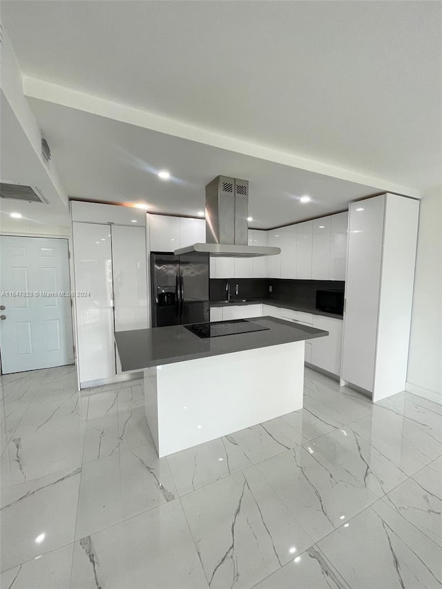 kitchen featuring island range hood, white cabinetry, a kitchen island, and black appliances