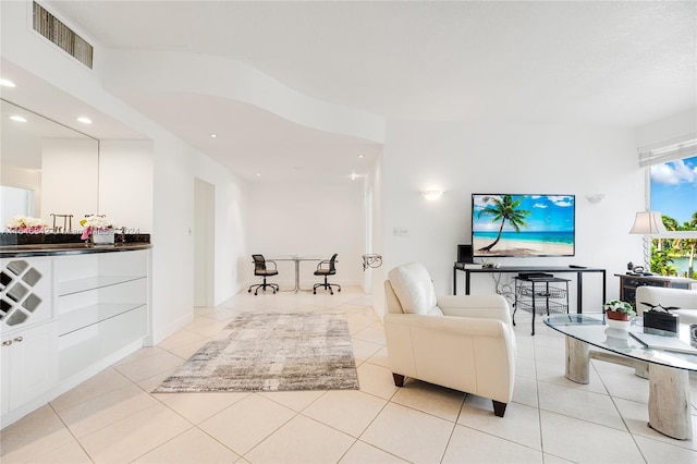 living room featuring light tile patterned flooring, visible vents, and recessed lighting