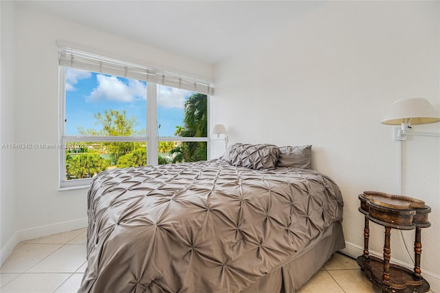 bedroom with baseboards and light tile patterned floors