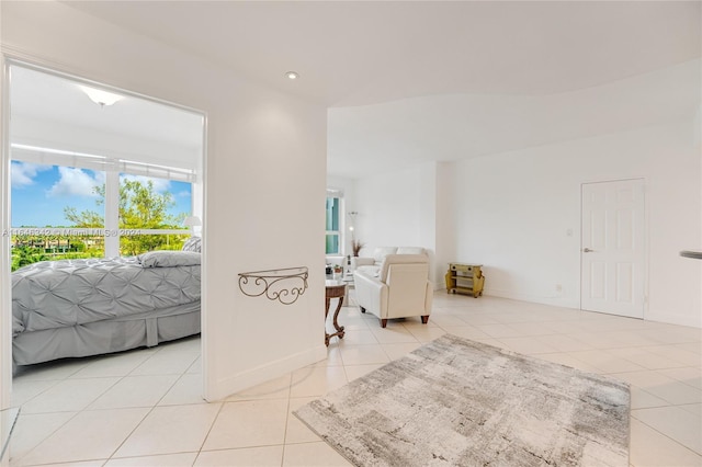 interior space with recessed lighting, baseboards, and light tile patterned floors