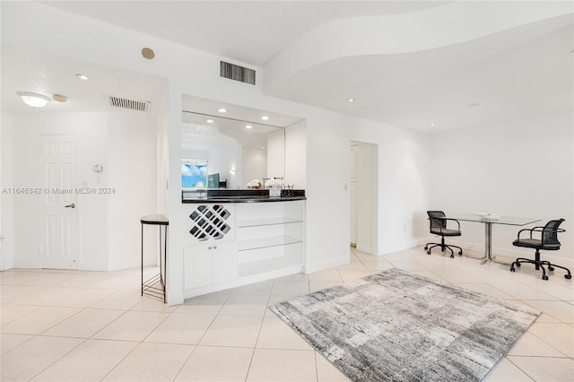 interior space featuring white cabinets and light tile patterned floors