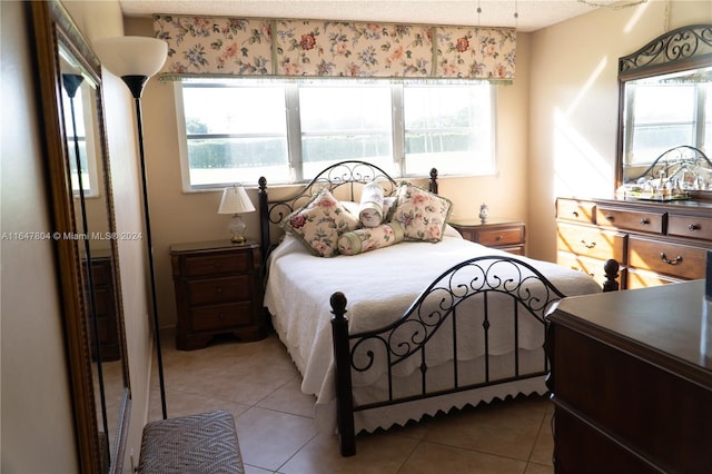 bedroom featuring tile patterned flooring and multiple windows