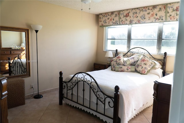 bedroom featuring a textured ceiling and tile patterned floors