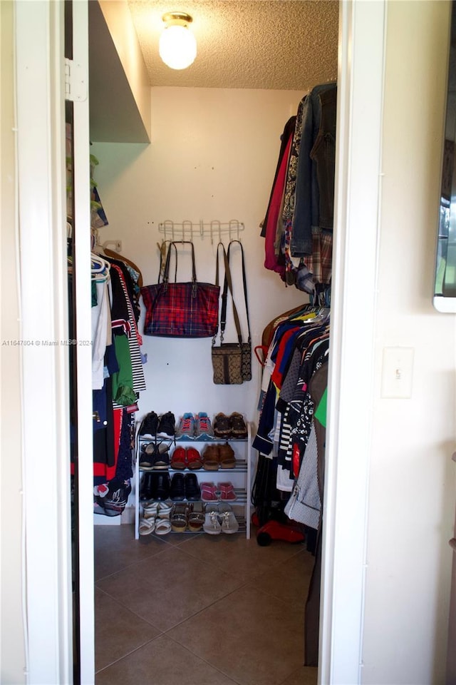 spacious closet featuring tile patterned floors