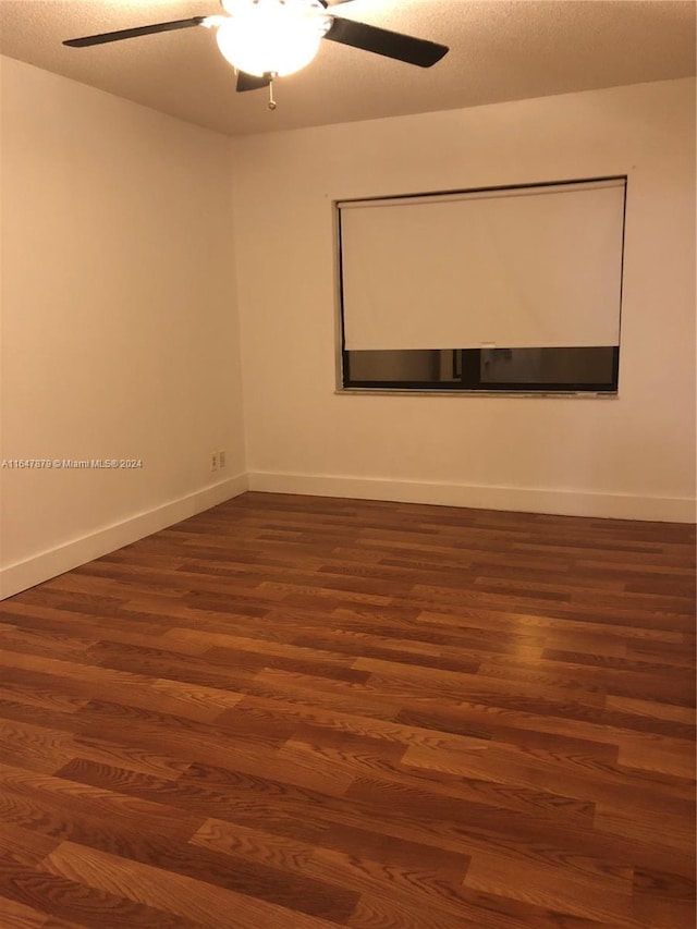 unfurnished room featuring ceiling fan, wood-type flooring, and a textured ceiling