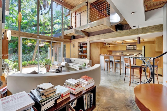 interior space featuring concrete floors and a towering ceiling