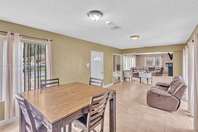 dining space featuring light tile patterned floors