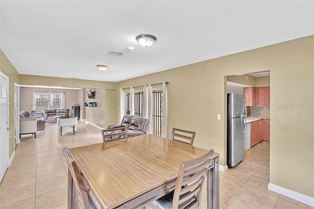 dining space featuring light tile patterned floors