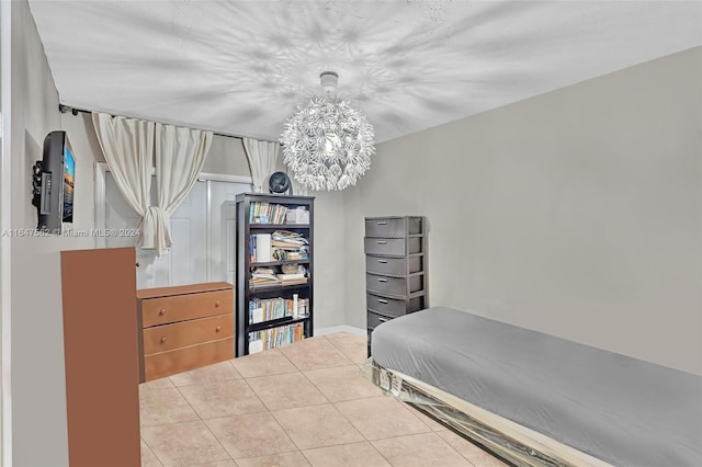 bedroom with tile patterned floors and a chandelier