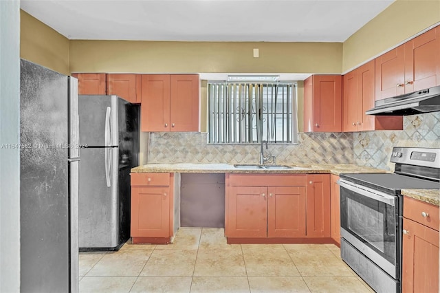 kitchen with light tile patterned floors, sink, stainless steel appliances, and tasteful backsplash