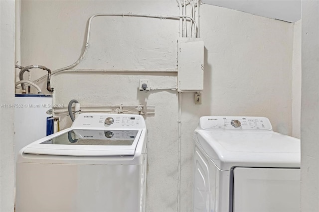 washroom featuring washing machine and dryer and water heater