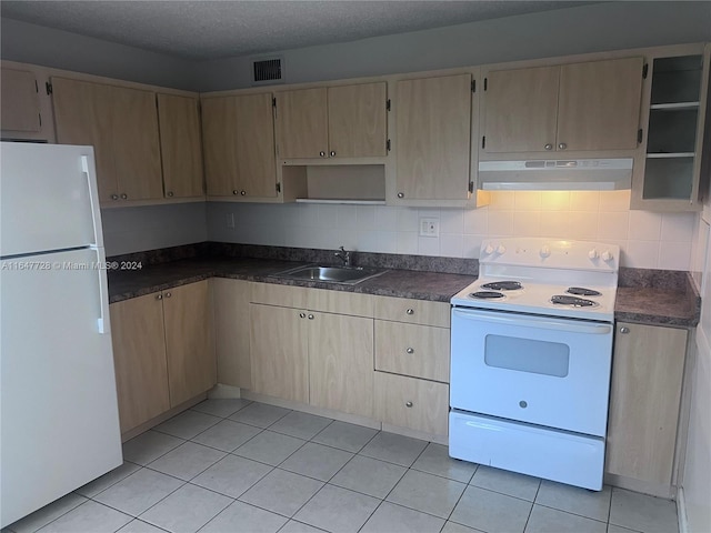 kitchen featuring white appliances, sink, a textured ceiling, light tile patterned floors, and light brown cabinets