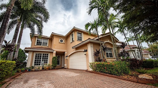 mediterranean / spanish-style house with a garage