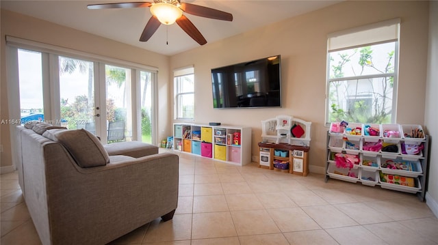 recreation room with light tile patterned floors and ceiling fan