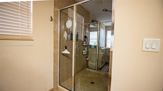 bathroom featuring a shower with shower door