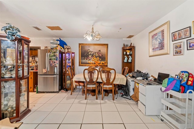 dining space with an inviting chandelier and light tile patterned floors