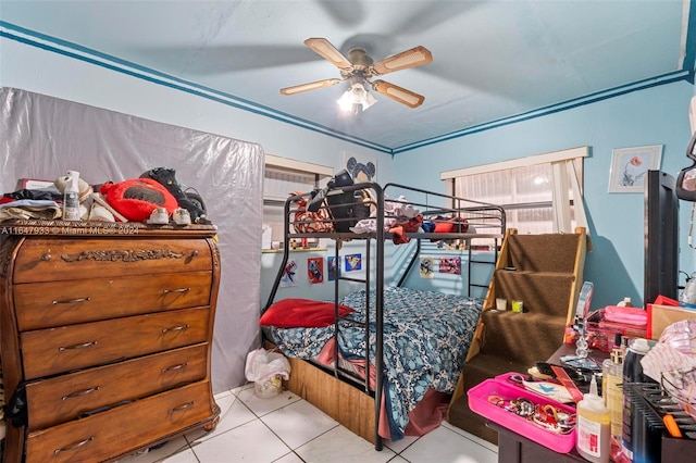 tiled bedroom with ceiling fan and ornamental molding