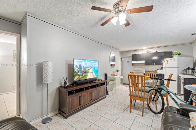 tiled living room featuring ceiling fan and a textured ceiling