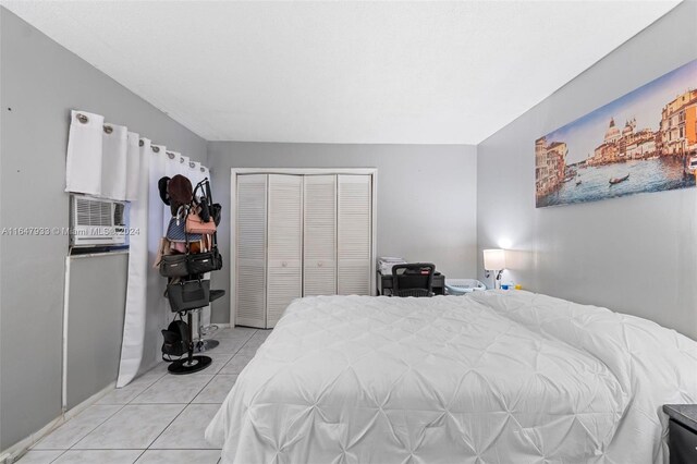 tiled bedroom with a closet