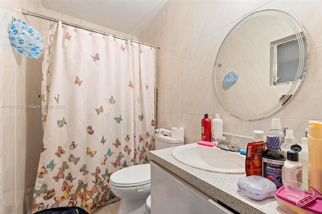 bathroom featuring toilet, vanity, tile walls, tile patterned floors, and walk in shower