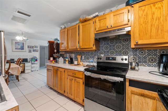 kitchen with decorative backsplash, a notable chandelier, electric range, and light tile patterned floors