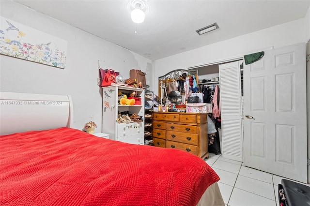 tiled bedroom with a closet