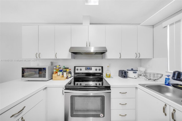 kitchen featuring sink, white cabinetry, and stainless steel range with electric stovetop