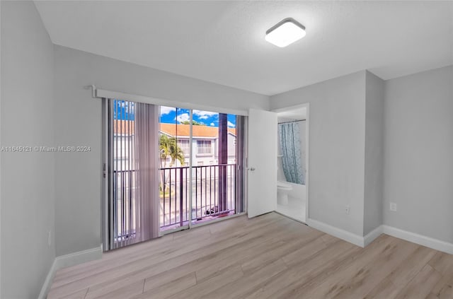 empty room with light hardwood / wood-style flooring