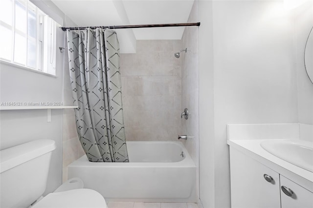 full bathroom featuring shower / bath combination with curtain, toilet, vanity, and tile patterned floors