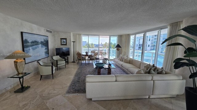 16400 Collins Ave Unit 646, Sunny Isles Beach, FL 33160 - living room with floor to ceiling windows, visible vents, and a textured ceiling