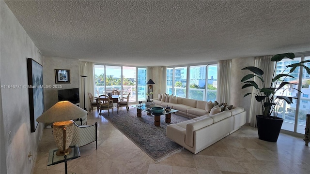 living room featuring floor to ceiling windows and a textured ceiling