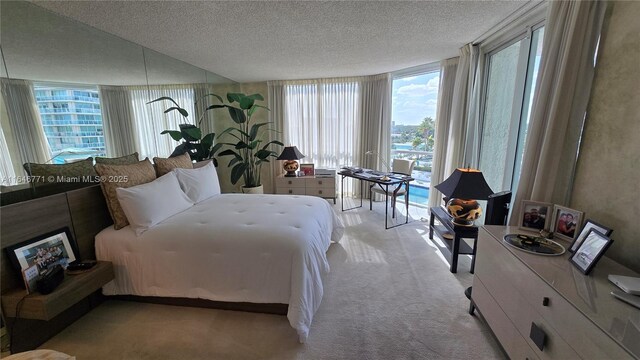 16400 Collins Ave Unit 646, Sunny Isles Beach, FL 33160 - kitchen with a textured ceiling, freestanding refrigerator, white cabinets, a wall of windows, and white microwave