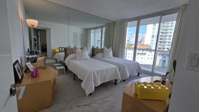16400 Collins Ave Unit 646, Sunny Isles Beach, FL 33160 - kitchen featuring white microwave, light countertops, white cabinets, under cabinet range hood, and a chandelier