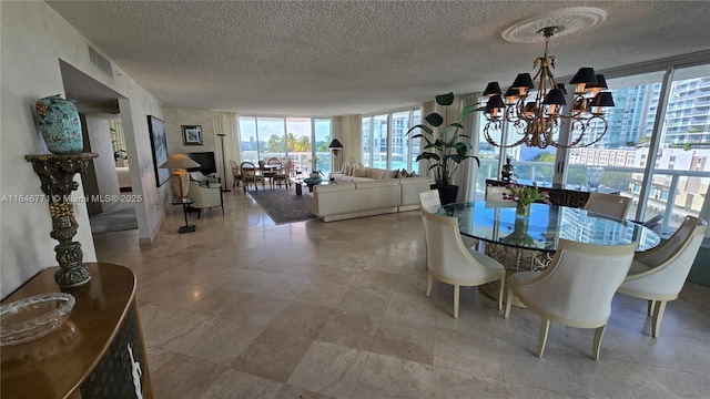 dining area with a notable chandelier, a wall of windows, and a textured ceiling