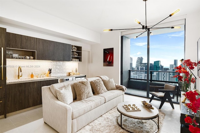 living room with light tile patterned floors, bar, and a chandelier