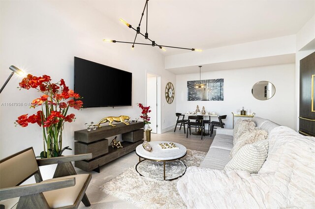 living room with a notable chandelier and light tile patterned floors