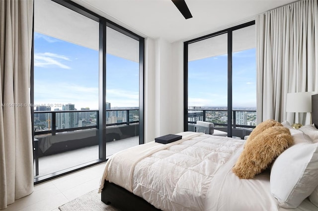 tiled bedroom with expansive windows, multiple windows, and ceiling fan