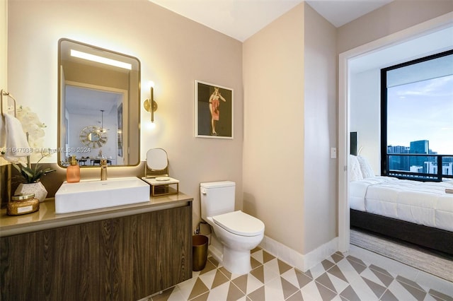 bathroom with vanity, tile patterned flooring, and toilet