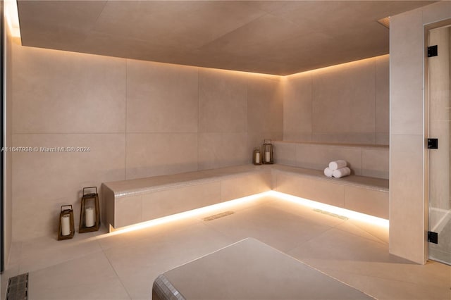 bathroom featuring tile patterned flooring and tile walls