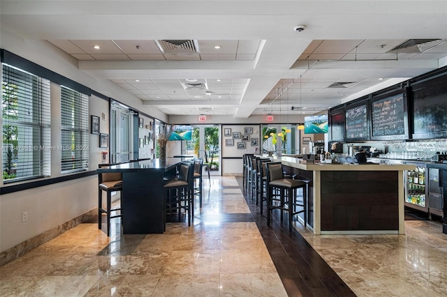 kitchen featuring a kitchen breakfast bar and tile patterned flooring