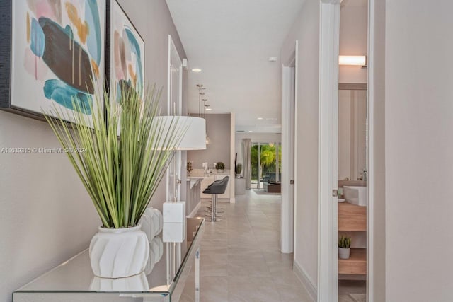 hall featuring light tile patterned flooring