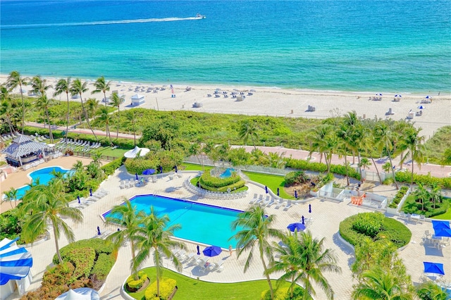 birds eye view of property with a view of the beach and a water view