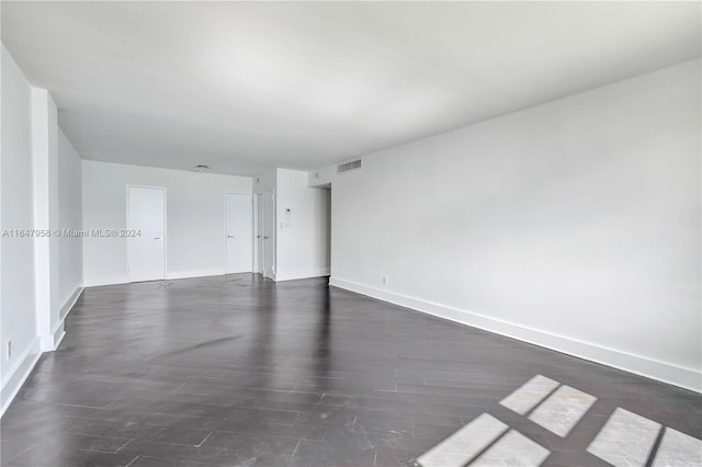 empty room featuring dark hardwood / wood-style flooring