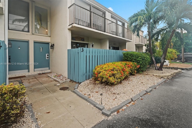 view of home's exterior featuring fence and stucco siding